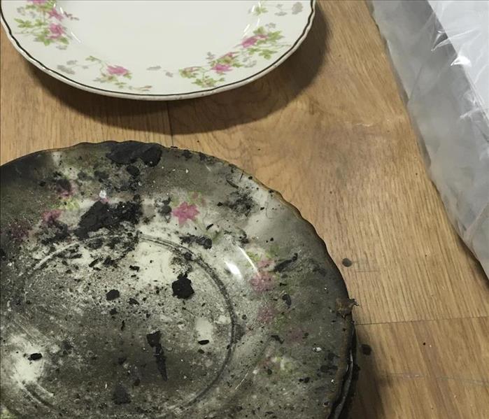 2 porcelain plates, one with fire damage and one clean.