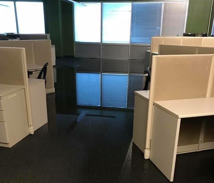 Commercial office space with standing water.